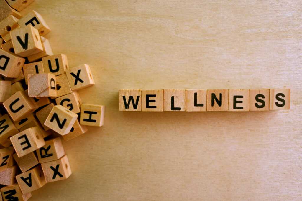 Wellness,Word,Cube,On,Wood,Background,,english,Language,Learning,Concept