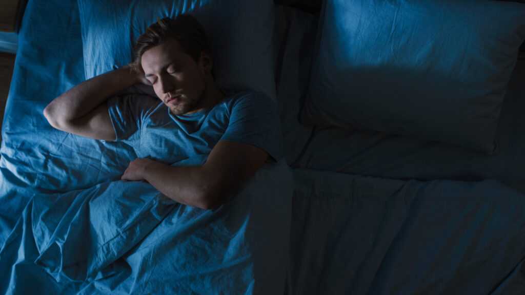 Top,View,Of,Handsome,Young,Man,Sleeping,Cozily,On,A