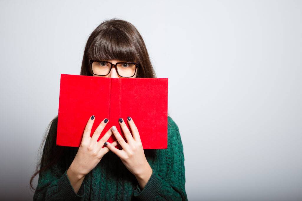 Long-haired,Girl,Hides,Behind,The,Book,,A,Student,In,Isolation